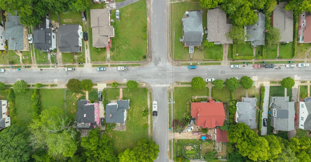 An aerial view of an intersection in a suburban neighborhood.