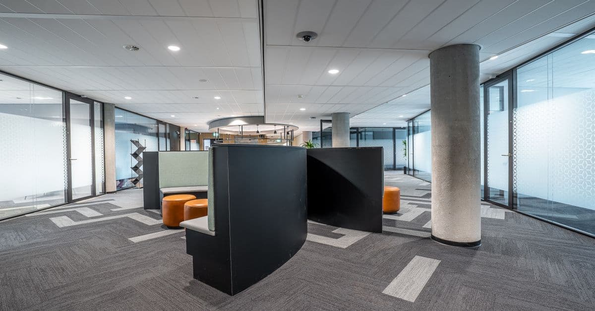 A spacious modern office interior with an open workspace.