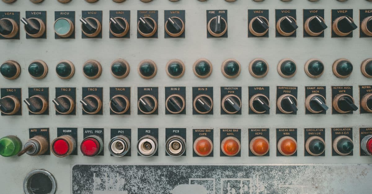 Close-up of a vintage industrial control panel with multiple buttons and switches.