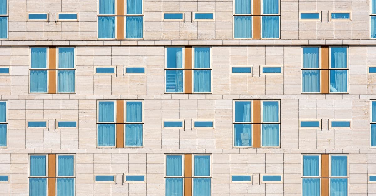 A modern facade of repeating symmetrical windows.